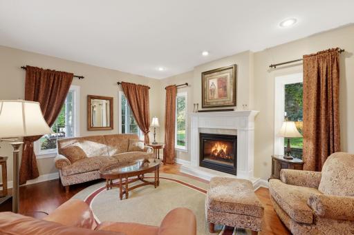 View of the den that is just off the entryway, a perfect place to enjoy a book by the fireplace.