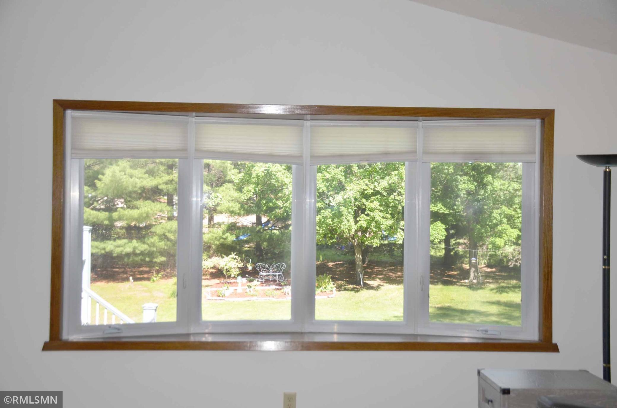 beautiful 4 panel bay window looking into your beautiful back yard