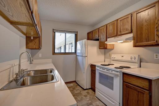 Kitchen with new quartz countertops, sink, and faucet.