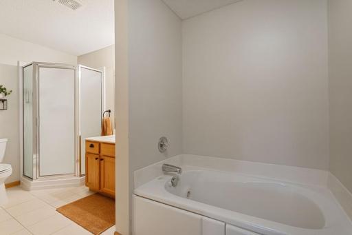 Master bath upgraded with tiled floor and whirlpool tub and separate shower