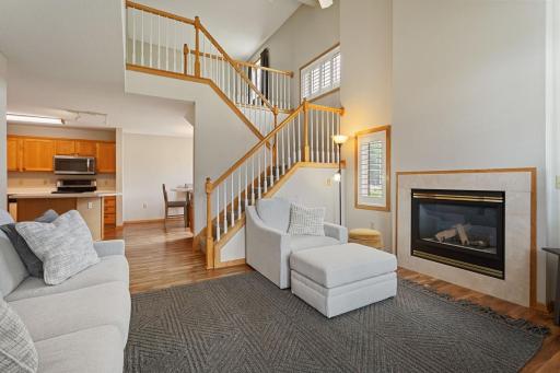 Vaulted 2 story living room with ceiling fan above