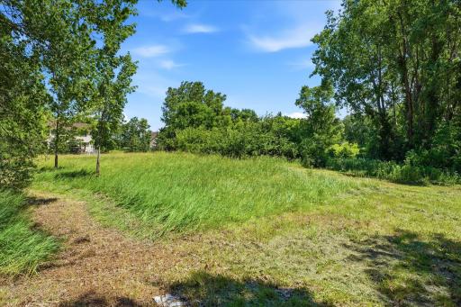 Possible future level building pad area. Fire hydrant located near lot line