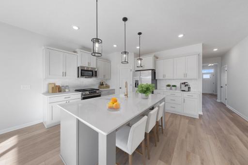 Representational Purposes Only. Nice Kitchen with Roomy Island ,with sleek brushed gold sleek high arc pullown fuacet by Moen! Virtually Staged