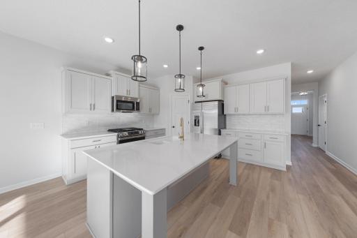 Representational Purpose Only. Kitchen View- wonderful quartz counterspace next to the refrigerator.