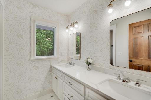 Third upstairs bathroom, with twin sinks and private toilet closet.