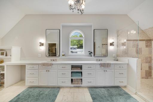 Large primary bathroom suite with standalone soaking tub and step in shower.