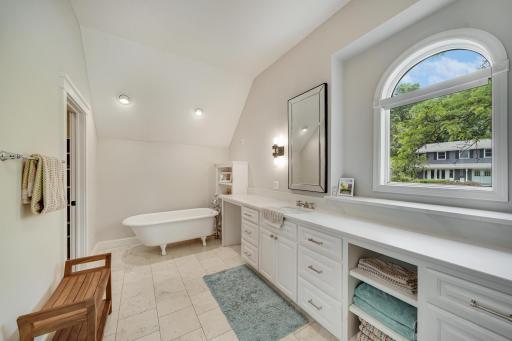 Large primary bathroom with standalone soaking tub and step in shower.