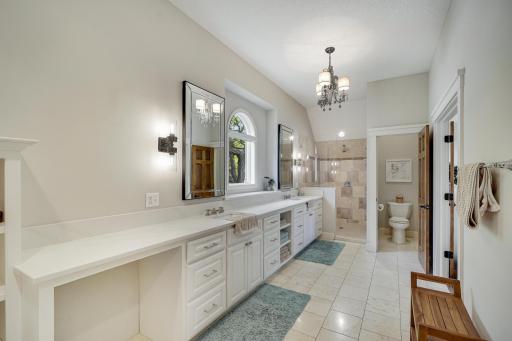 Twin sinks, walk-in shower and private toilet closet.