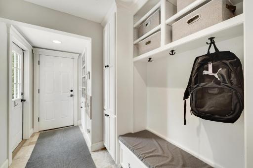 Mudroom with built in cubbies from garage.