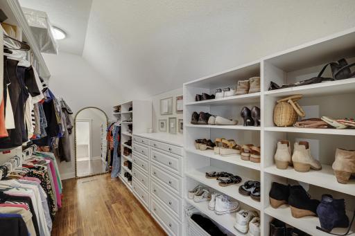 Enormous primary walk-in closet with built in storage.