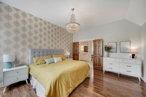 Upstairs primary bedroom with spacious closets, large bathroom suite, walk-in closet and vaulted ceilings.