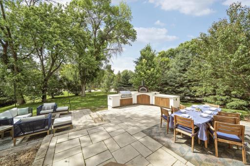 Beautiful backyard patio with outdoor pizza oven and grill!