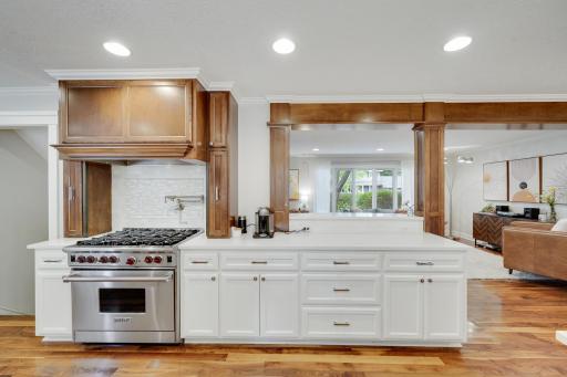 Kitchen opens to living room with breakfast bar.