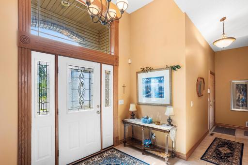 The spacious foyer offers abundant natural light, elegant wood trim, and an open view into the main living areas beyond.