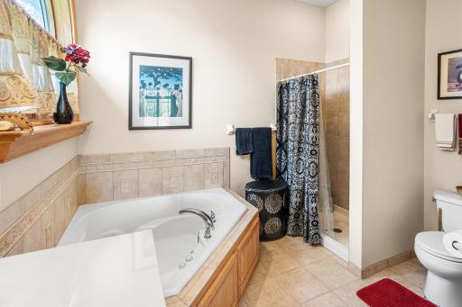 Relax in the jetted soaking tub or enjoy the separate walk-in shower in the spacious primary bath.