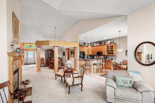 The open-concept design allows the kitchen, dining spaces, and living room to flow together while maintaining defined gathering areas.
