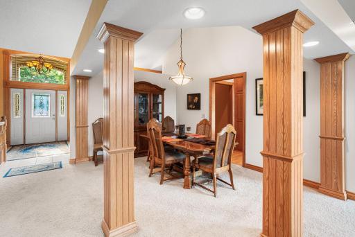 Elegant architectural columns define the formal dining room while maintaining an open flow to the surrounding living spaces.