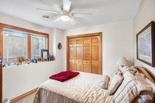 An additional lower-level bedroom features a generous closet, daylight window, and flexible space for guests, hobbies, or a home office.