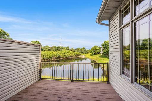 A spacious maintenance-free deck overlooks the pond, offering an ideal spot for relaxing, dining, or enjoying the surrounding scenery.