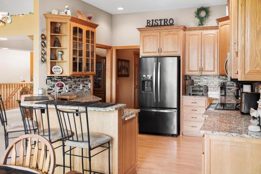 The spacious center island provides additional prep space, storage, seating, and a convenient sink for everyday functionality.