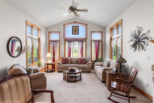 A wall of oversized windows and transoms fills the living room with natural light while highlighting the home's impressive ceiling height.