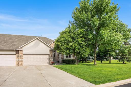 Welcome home to this beautifully maintained end-unit twinhome featuring an attached two-car garage, mature landscaping, and a peaceful setting.