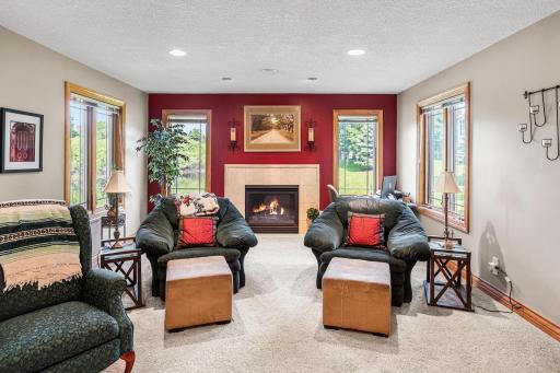 This floorplan features a "bump out" sunroom creating cozy sitting area centered around the gas fireplace creates an inviting space to relax while enjoying views of the pond and surrounding greenspace.