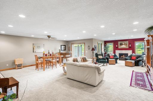 The finished walkout lower level provides an expansive family room with multiple gathering spaces, recessed lighting, and access to the backyard patio.