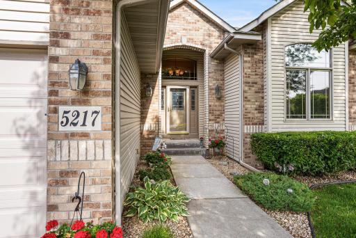 Step through the impressive covered entry with transom windows and decorative glass front door into a grand foyer.