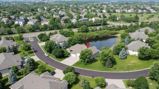 neighborhood view highlights the pond, surrounding walking areas, and thoughtfully planned community with spacious homesites and abundant open green space.