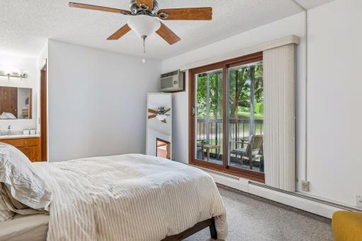 Primary bedroom with its own enclosed porch and 3/4 bathroom
