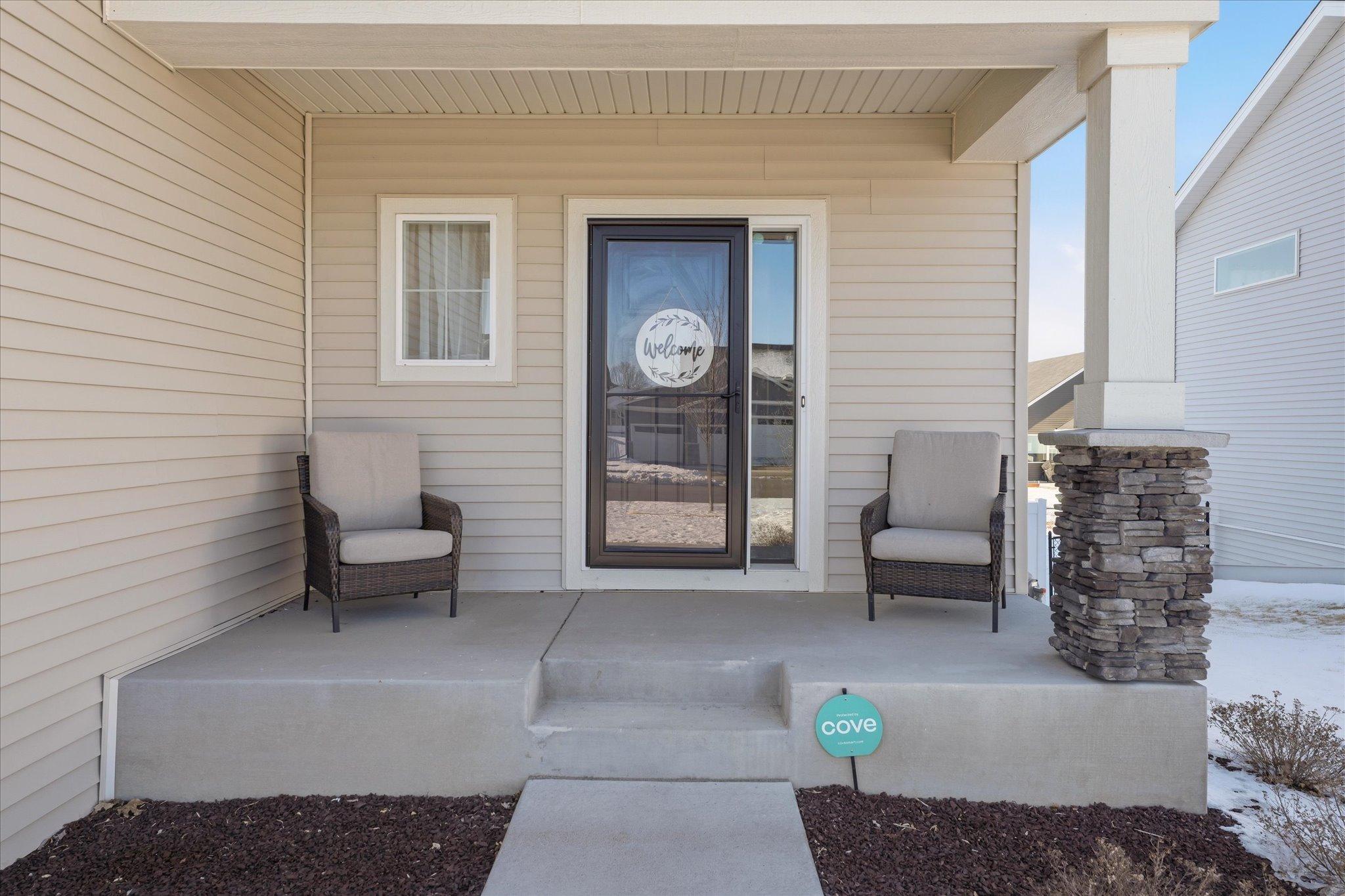 Welcome your guests from your concrete front covered porch!