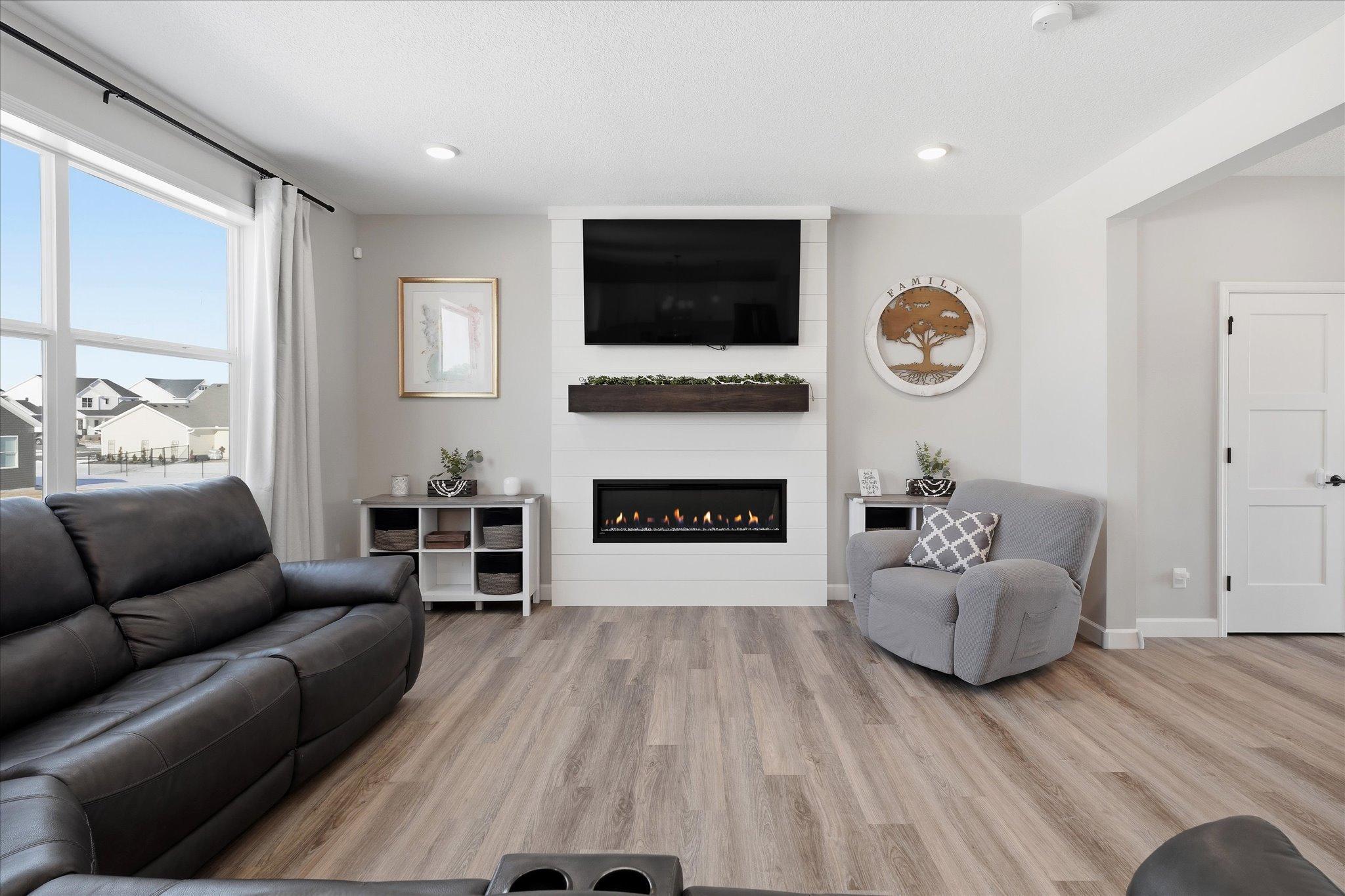 Fireplace is a fantastic focal point. Giving the open layout a cozy space to warm by the fire.