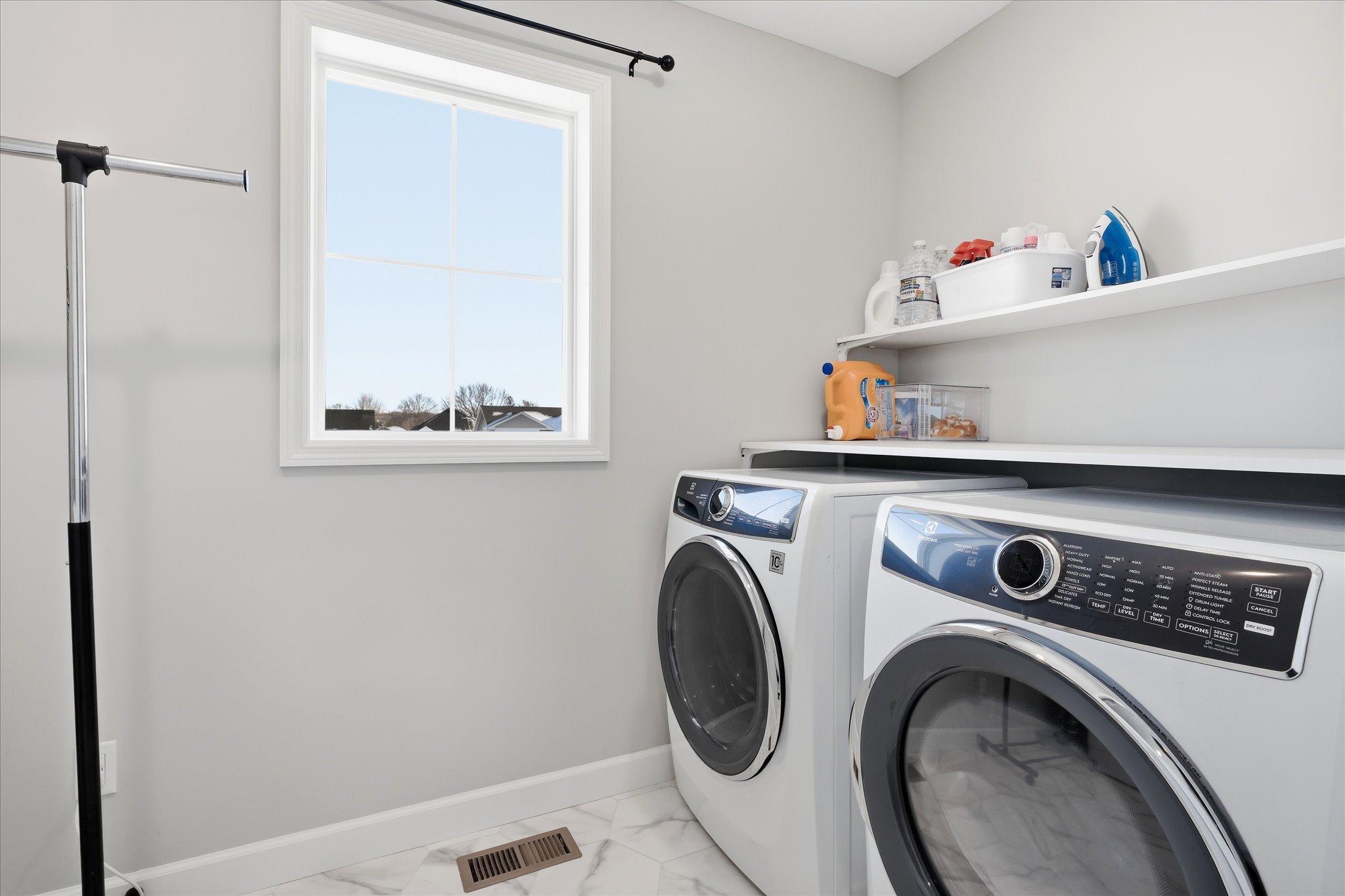 Upper Level large laundry room with shelf and sink