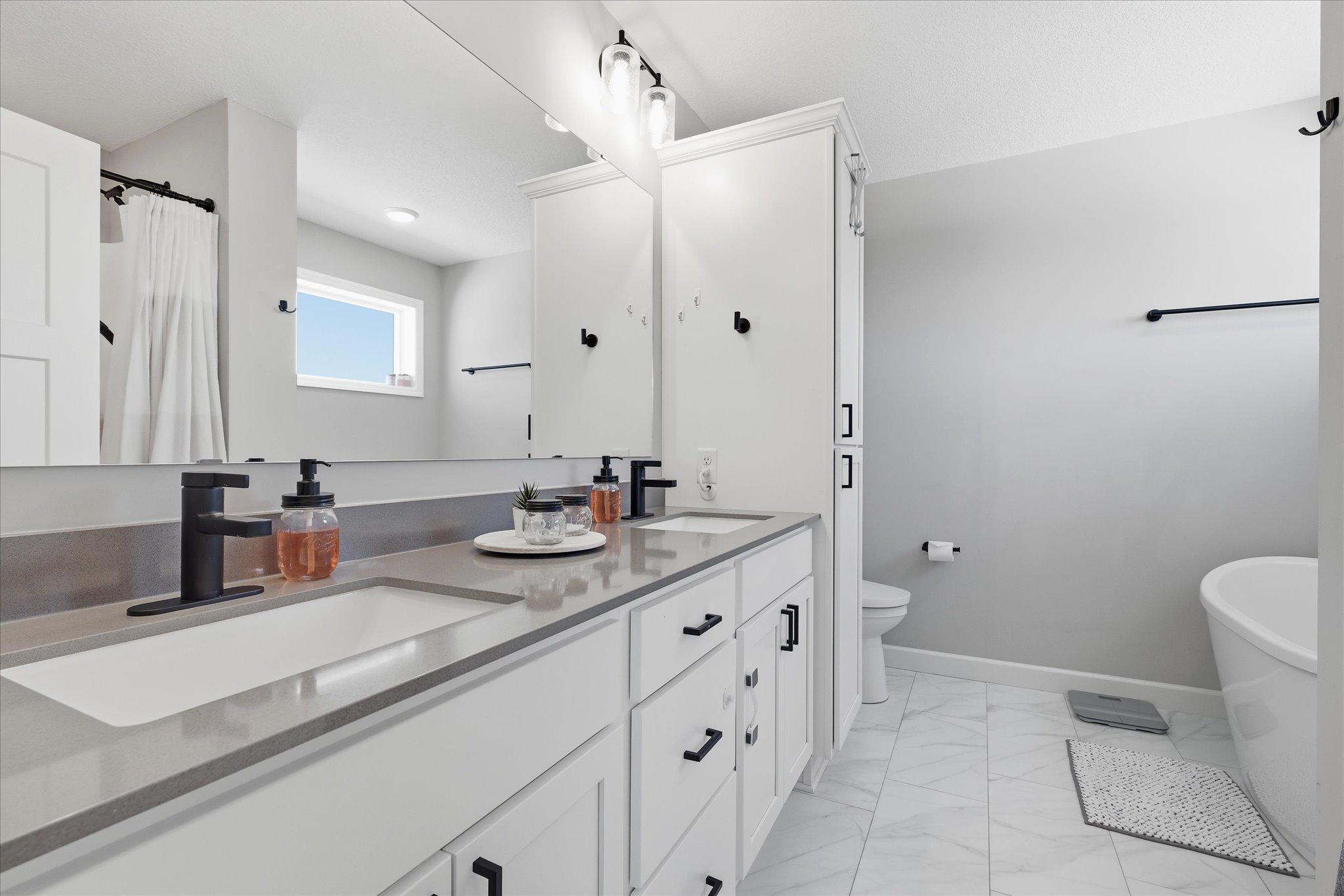 Primary ensuite with spa-like soaking tub and separate shower