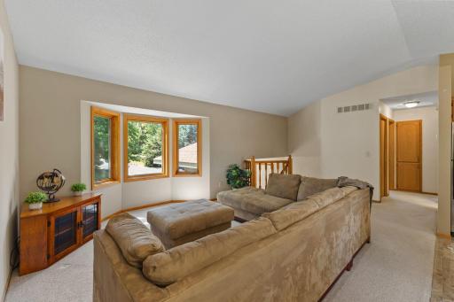 This view overlooks the front yard sprinkled with mature trees.