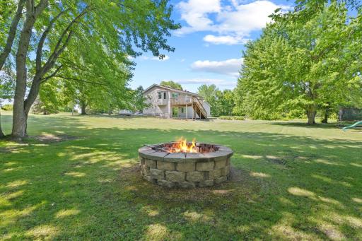Towards the right side of the backyard, you'll find this enormous fire pit. Perfect for spring and fall days, and chilly summer evenings.