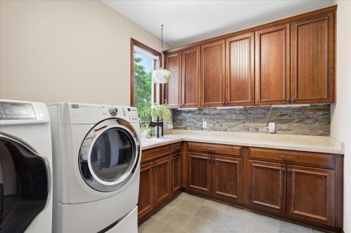 Laundry room complete with laundry sink and plenty of storage.