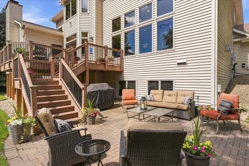 Stairs from back deck to the beautifully paved back porch living space.