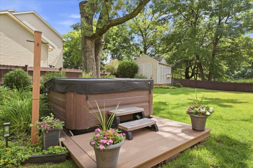 Hot tub off of the back porch provides relaxation in a serene setting.
