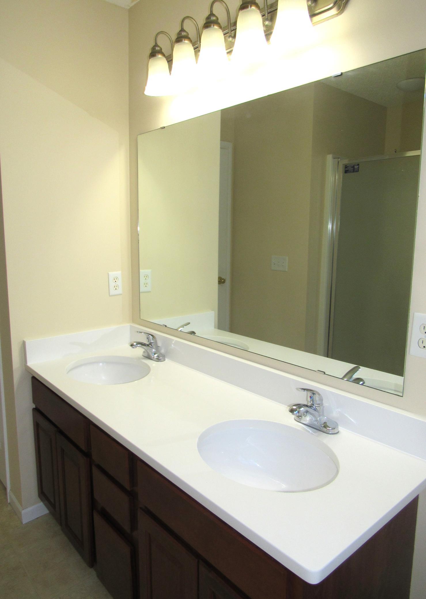 Another perk in the primary ensuite are the dual sinks. The new quartz counter looks great. There is a linen closet, medicine cabinet and updated lighting.