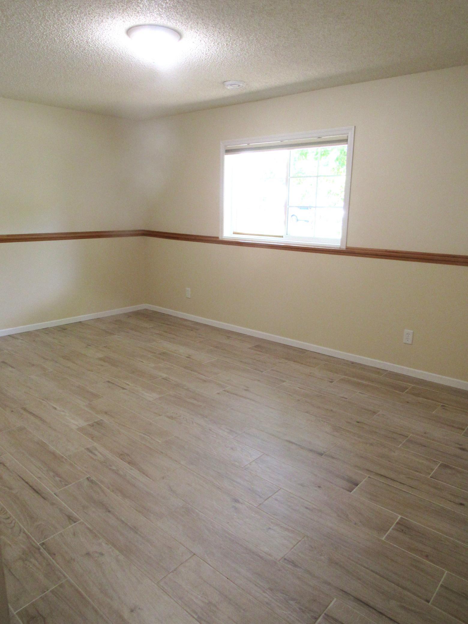 Here is the versatile lower level w/easy care tile flooring throughout-new in 2024! There is a closet and 3/4 bath, freshly painted 6/2026. Turn it into a bedroom, office, family room, playroom or craft room! The day windows bring in lots of light.