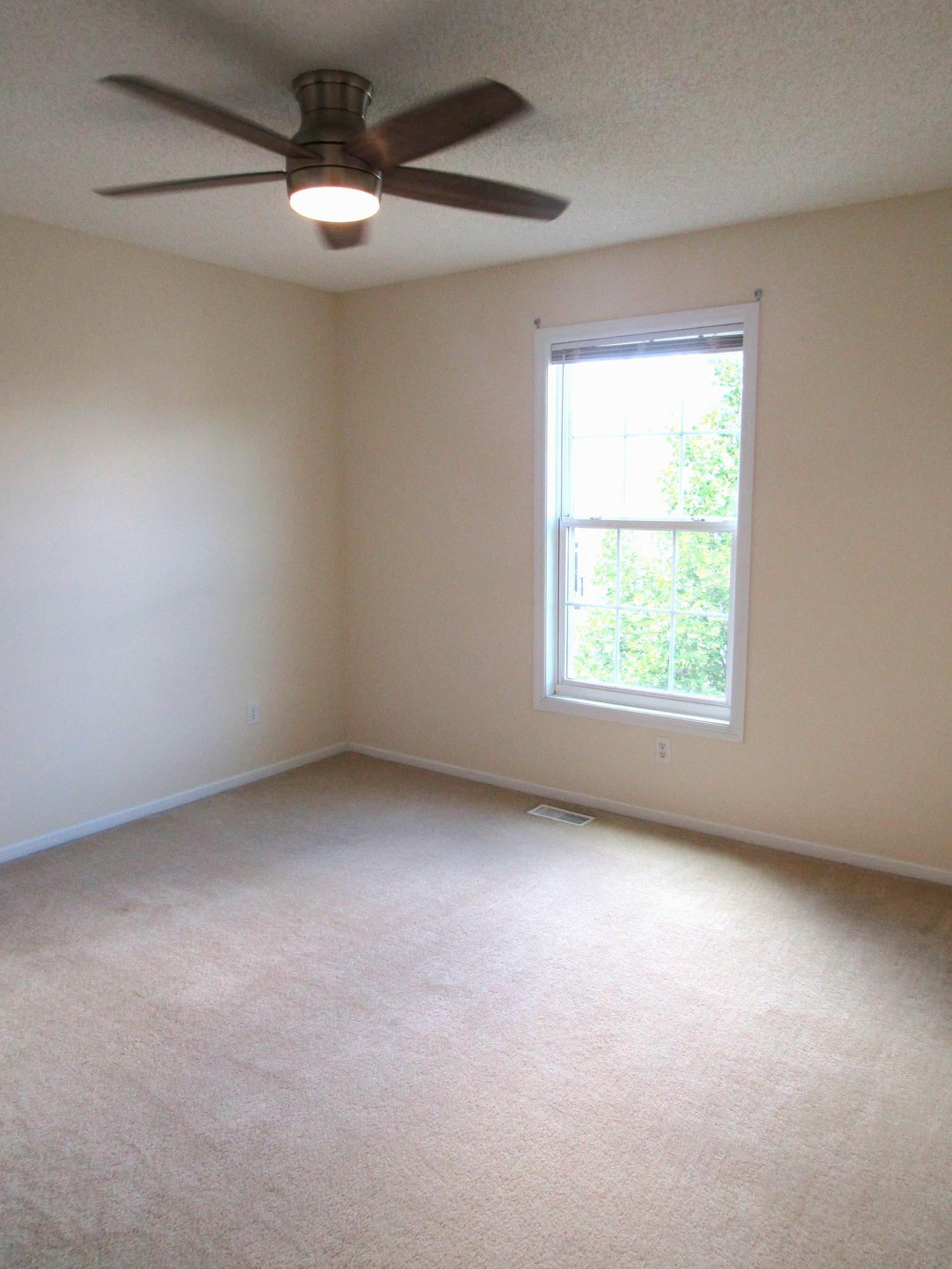 One of the 3 upper level bedrooms with a spacious double closet, brushed nickel ceiling light with fan and remote. Freshly painted in a neutral color! 11.6x11.6