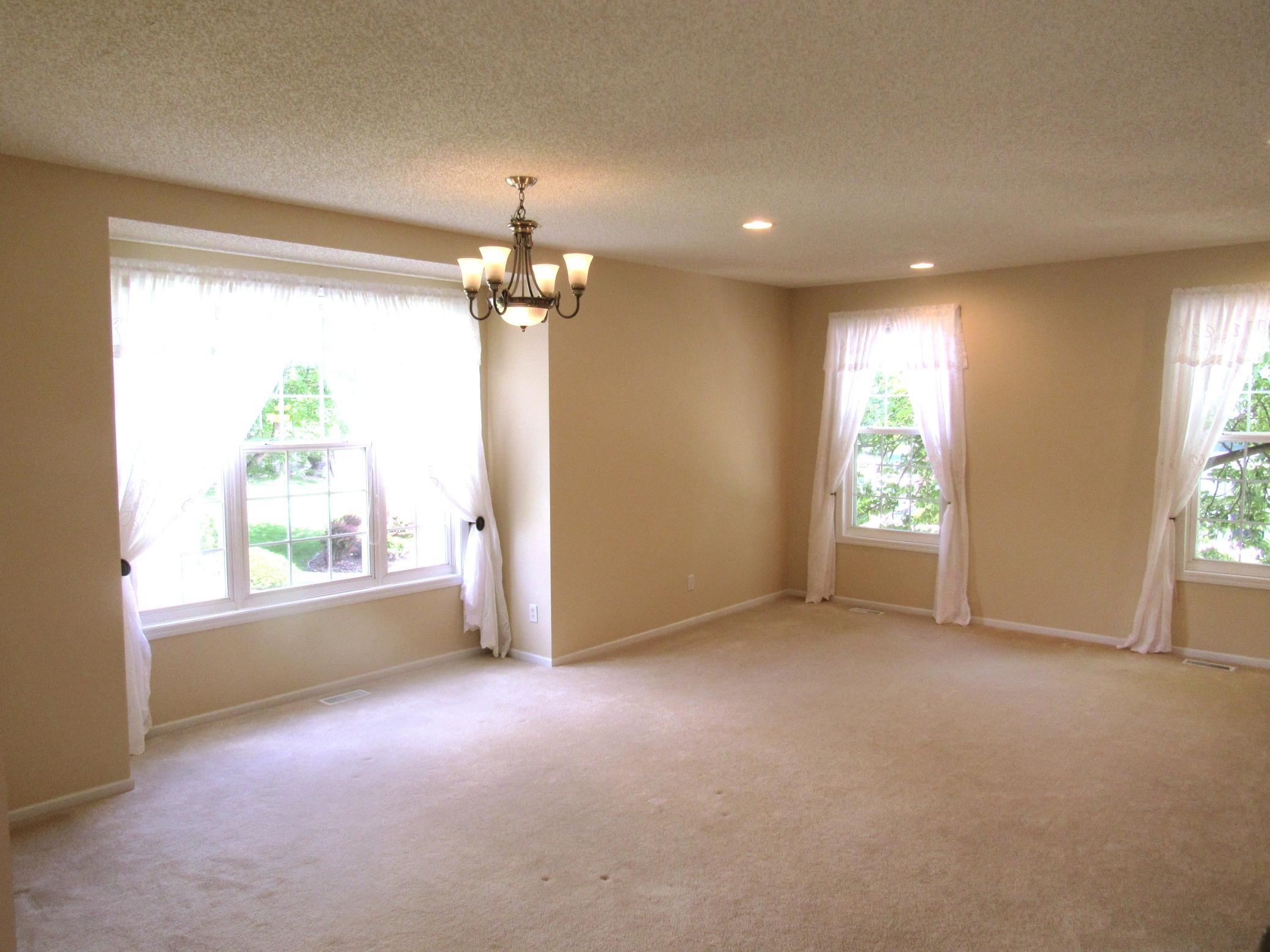 The huge dining room and living room with a box window, recessed lights and fresh paint plus the carpet was professionally cleaned.
