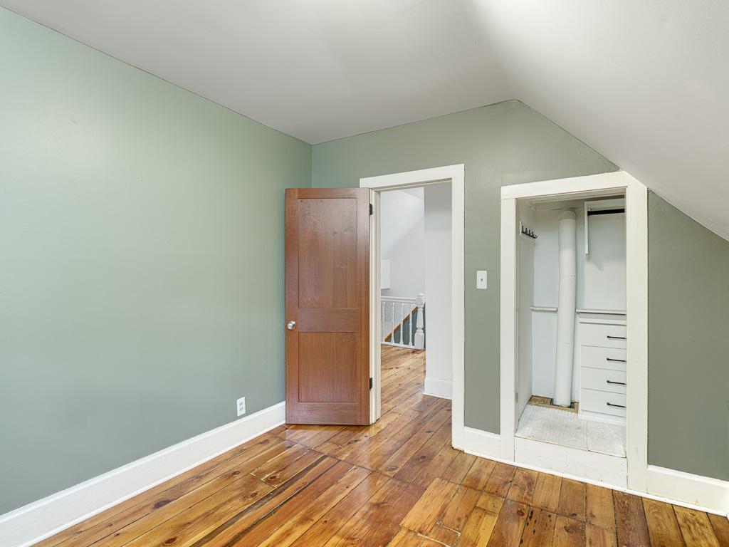 A second upstairs bedroom is roomy and includes a custom closet insert.