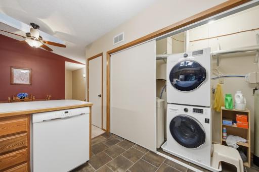 Conveniently located stackable washer and dryer with extra storage, just off the kitchen
