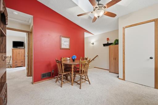 Natural light pours through the skylight, making this open dining area perfect for everyday meals and entertaining