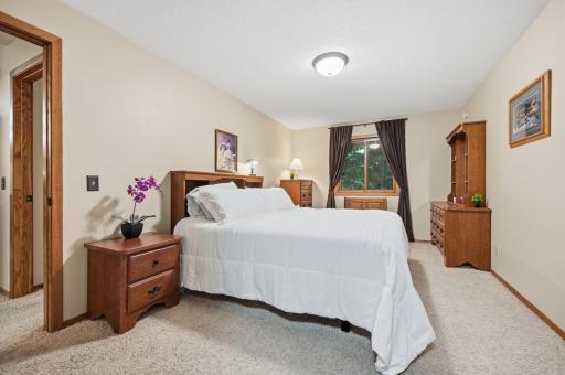 Spacious primary bedroom with room for a California King bed and a full complement of bedroom furniture.