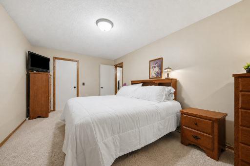 Spacious primary bedroom with room for a California King bed and a full complement of bedroom furniture.