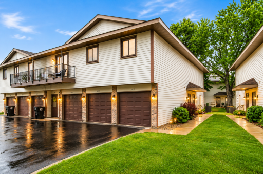 Highly sought-after upper-level townhouse offering one-level living, a private deck, and an attached garage